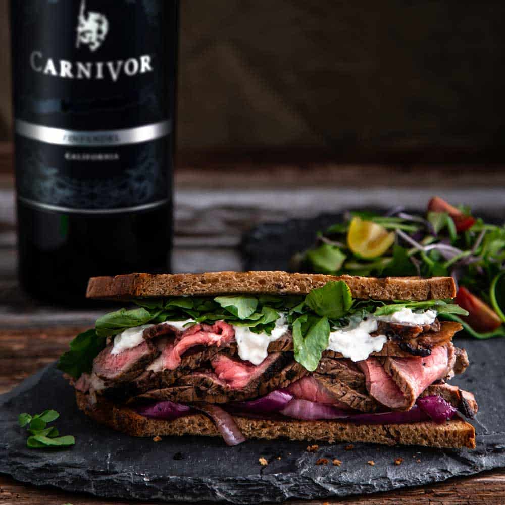 Steak Sandwiches with Grilled Onions, Creamy Horseradish Sauce paired with Carnivor Zinfandel